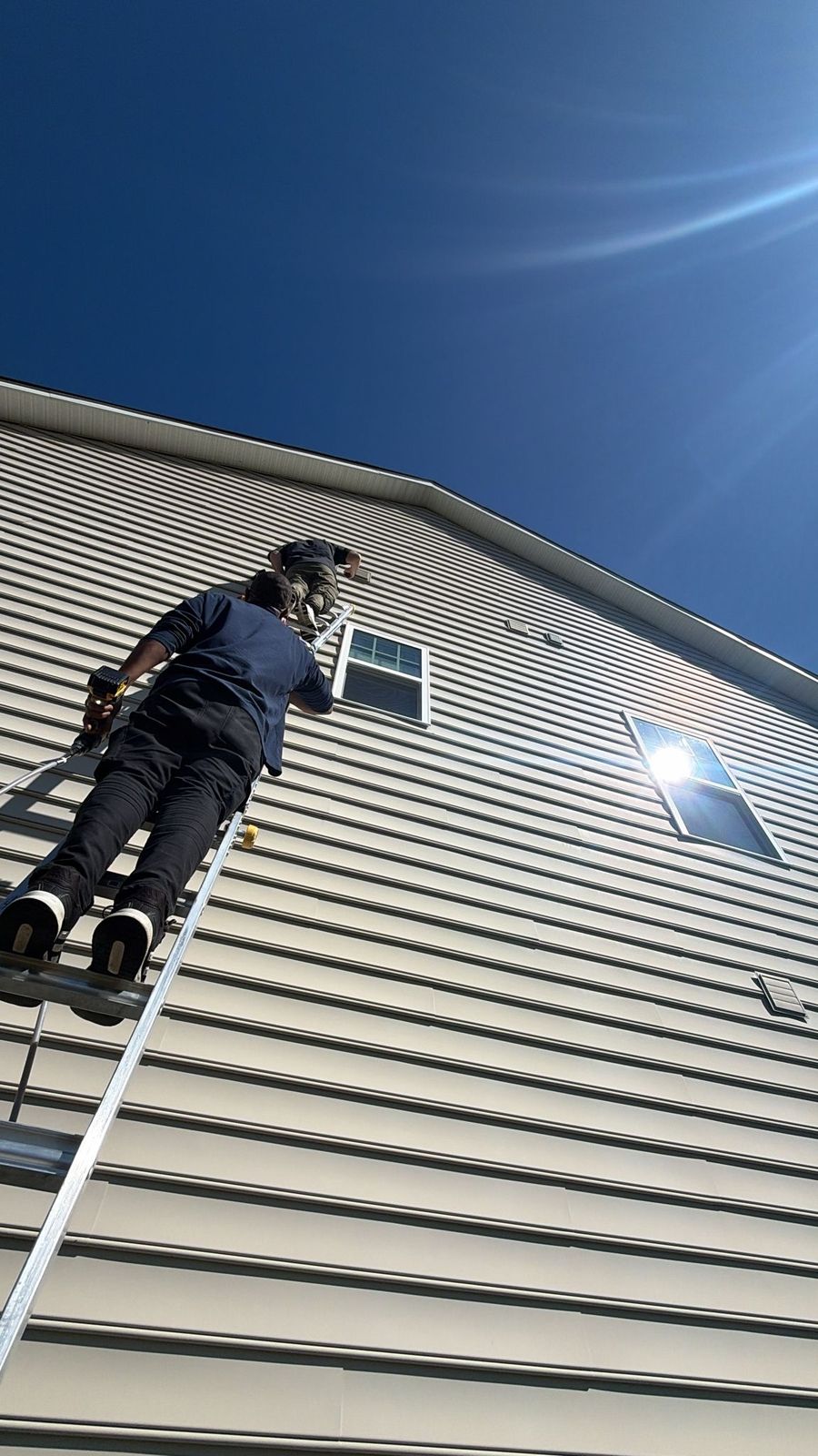 Our technicians cleaning a second-story dryer vent